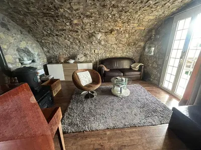 a living room with a couch and a rug at Maison de charme piscine vue mer in Èze