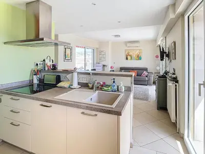 a kitchen with a sink and a counter at Penthouse d'exception avec terrasse panoramique in Nice
