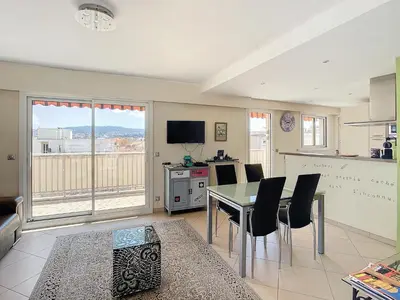 a kitchen and dining room with a table and chairs at Penthouse d'exception avec terrasse panoramique in Nice