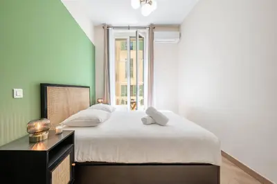 a bedroom with a large bed and a window at Magnifique - 2 chambres - Cœur de Nice avec Balcon in Nice