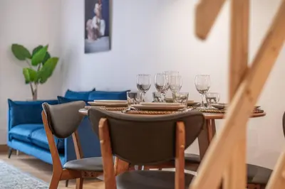 a dining room table with wine glasses on it at Magnifique - 2 chambres - Cœur de Nice avec Balcon in Nice