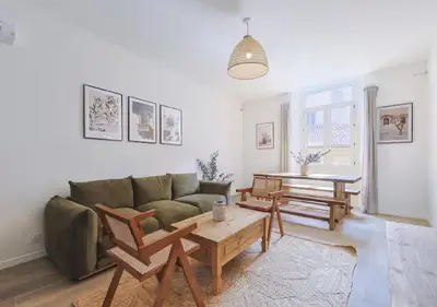 a living room with a couch and a table at Élégance & confort au cœur du Vieux Nice in Nice
