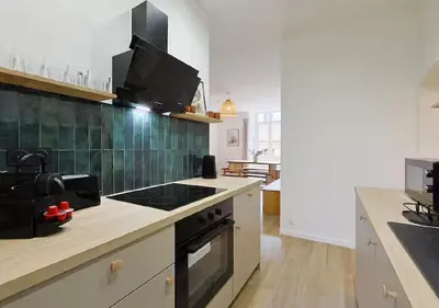 a kitchen with a stove and a counter top at Élégance & confort au cœur du Vieux Nice in Nice