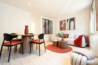 a living room with a table and chairs and a couch at Splendide Appartement Rénové Au Cœur du Vieux Nice in Nice