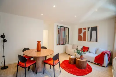 a living room with a couch and a table and chairs at Splendide Appartement Rénové Au Cœur du Vieux Nice in Nice