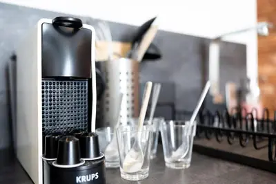 a coffee maker sitting on top of a counter with glasses at Moderne et lumineux en centre-ville - 2 Chambres in Nice