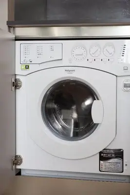 a white washing machine is in a kitchen at Moderne et lumineux en centre-ville - 2 Chambres in Nice