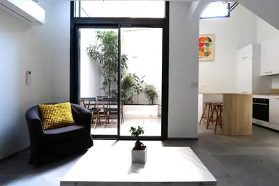 a living room with a chair and a table at Nümad Suites in Nice