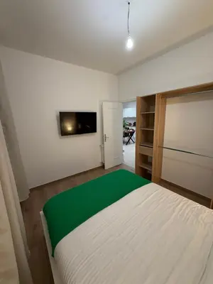 a bedroom with a white bed and a television at Nice - 6 personnes - 3 lits - 3 pièces - Parking ! in Nice
