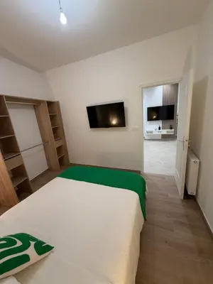 a bedroom with a white bed and a flat screen tv at Nice - 6 personnes - 3 lits - 3 pièces - Parking ! in Nice