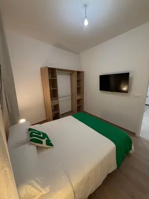 a bedroom with a large bed and a flat screen tv at Nice - 6 personnes - 3 lits - 3 pièces - Parking ! in Nice
