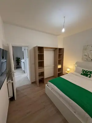a bedroom with a large bed and a television at Nice - 6 personnes - 3 lits - 3 pièces - Parking ! in Nice