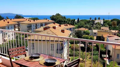 a balcony of a house with a view of a city at PANORAMIC SEA VIEW with PRIVATE PARKING and AC in Nice
