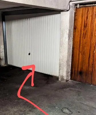 a red hose is attached to a garage door at PANORAMIC SEA VIEW with PRIVATE PARKING and AC in Nice
