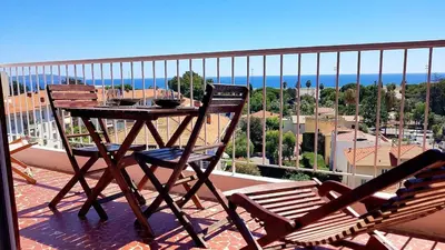 a table and chairs on a balcony with a view at PANORAMIC SEA VIEW with PRIVATE PARKING and AC in Nice