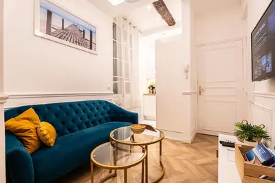 a living room with a blue couch and a table at La Bellanda - Au coeur du Vieux Nice in Nice