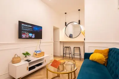 a living room with a blue couch and a mirror at La Bellanda - Au coeur du Vieux Nice in Nice