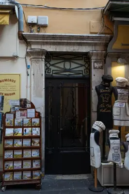 a store front with a black door with a lot of merchandise at La Bellanda - Au coeur du Vieux Nice in Nice