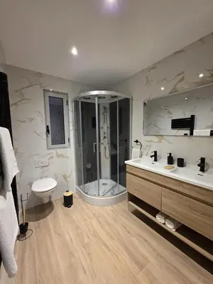 a bathroom with a tub and a shower and a sink at La costière in Nice