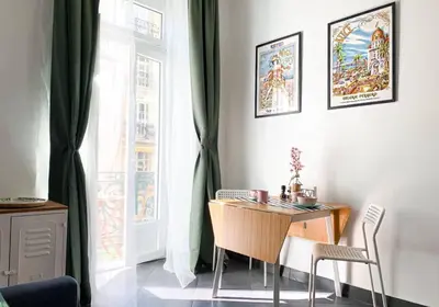 a table and chairs in a room with a window at DeLuxe Studio Cosy, Promenade des Anglais, NICE CENTRE in Nice