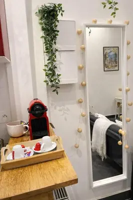 a small kitchen with a table and a mirror at DeLuxe Studio Cosy, Promenade des Anglais, NICE CENTRE in Nice