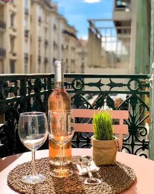 a bottle of wine and two glasses on a table at DeLuxe Studio Cosy, Promenade des Anglais, NICE CENTRE in Nice