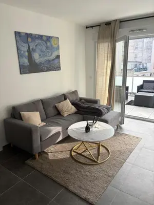 a living room with a couch and a table at Le Bonappart T3 Grande Terrasse in Nice
