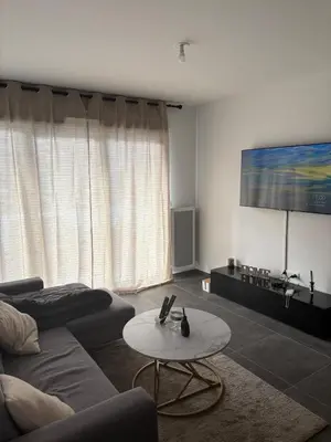 a living room with a couch and a table at Le Bonappart T3 Grande Terrasse in Nice