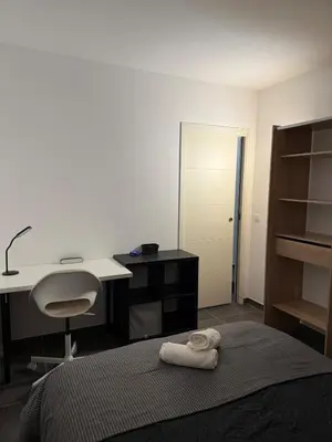 a bedroom with a desk and a bed and a desk and a chair at Le Bonappart T3 Grande Terrasse in Nice
