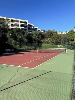 a tennis court with a net on top of it at Le Ciel de Fabron Piscine et Tennis in Nice