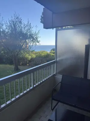 a balcony with a chair and a view of the ocean at Le Ciel de Fabron Piscine et Tennis in Nice