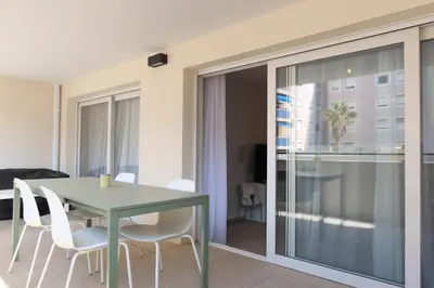 a table and chairs in a room with a building at Nice Time - Chic Apartment with sunny terrace, Nice Port in Nice