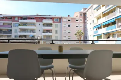 a table with plates and a green bottle on it at Nice Time - Chic Apartment with sunny terrace, Nice Port in Nice
