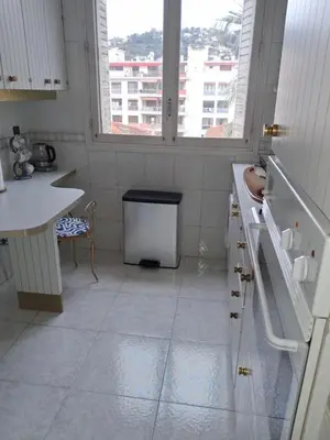 a white kitchen with a sink and a window at Appartement 4 couchages Nice in Nice
