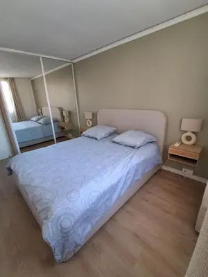 a bedroom with a large bed with two mirrors at Appartement 4 couchages Nice in Nice