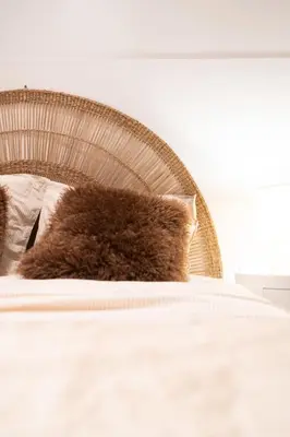 a brown cat laying on top of a bed at L'Adresse du Choeur - Vieux Nice in Nice