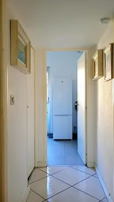 a hallway with a white door and a refrigerator at Artemare, il fascino del classico con ogni comfort in Nice