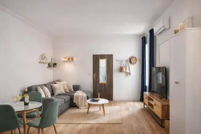 a living room with a couch and a table at Studio Carré Or avec balcon in Nice