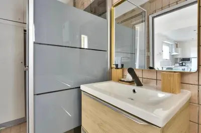 a bathroom with a white sink and a mirror at Studio Carré Or avec balcon in Nice