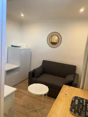 a living room with a couch and a table at Studio Nice cosy et plein centre in Nice