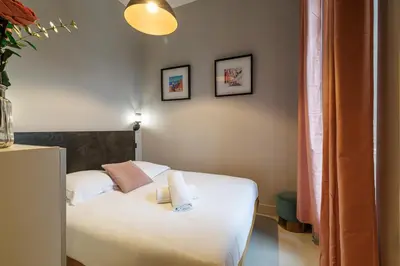 a living room with a couch and a desk and a television at Charming 1 Bdr Downtown in Nice