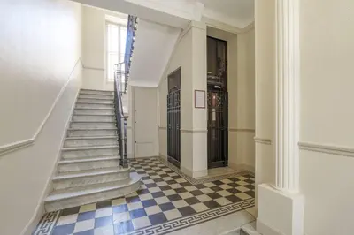 a staircase in a building with a checkered floor at Studio sous les toits, Nice Centre in Nice