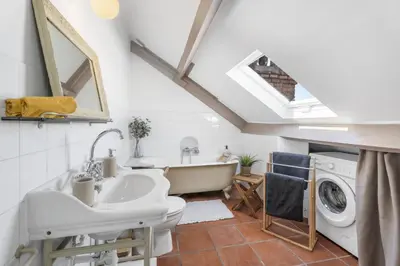 a bathroom with a sink and a washing machine at Studio sous les toits, Nice Centre in Nice