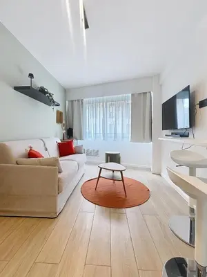 a living room with a couch and a table at Studio cosy Carré d 'Or de Nice in Nice
