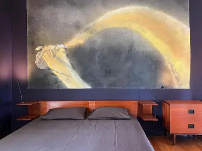 a bedroom with a bed and a painting on the wall at Design et Art in Nice