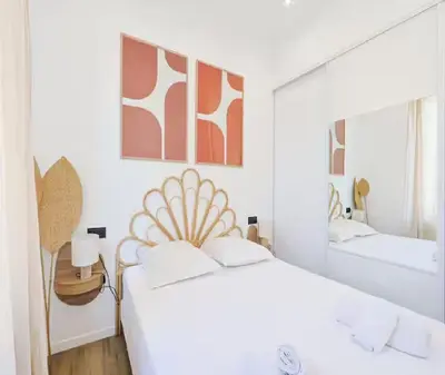 a white bedroom with two beds and a mirror at Splendide Appartement Neuf au Port de Nice in Nice