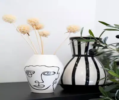 two vases sitting on a table with flowers in them at Splendide Appartement Neuf au Port de Nice in Nice