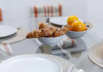 a table with two bowls of pastries and fruit at Le Bijou de Grimaldi Emplacement de Rêve Plage in Nice