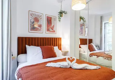 a bedroom with a bed with two swans on it at Le Bijou de Grimaldi Emplacement de Rêve Plage in Nice