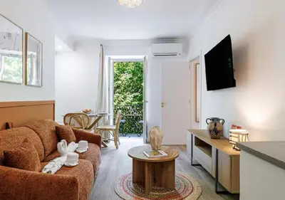 a living room with a couch and a table at Le Bijou de Grimaldi Emplacement de Rêve Plage in Nice
